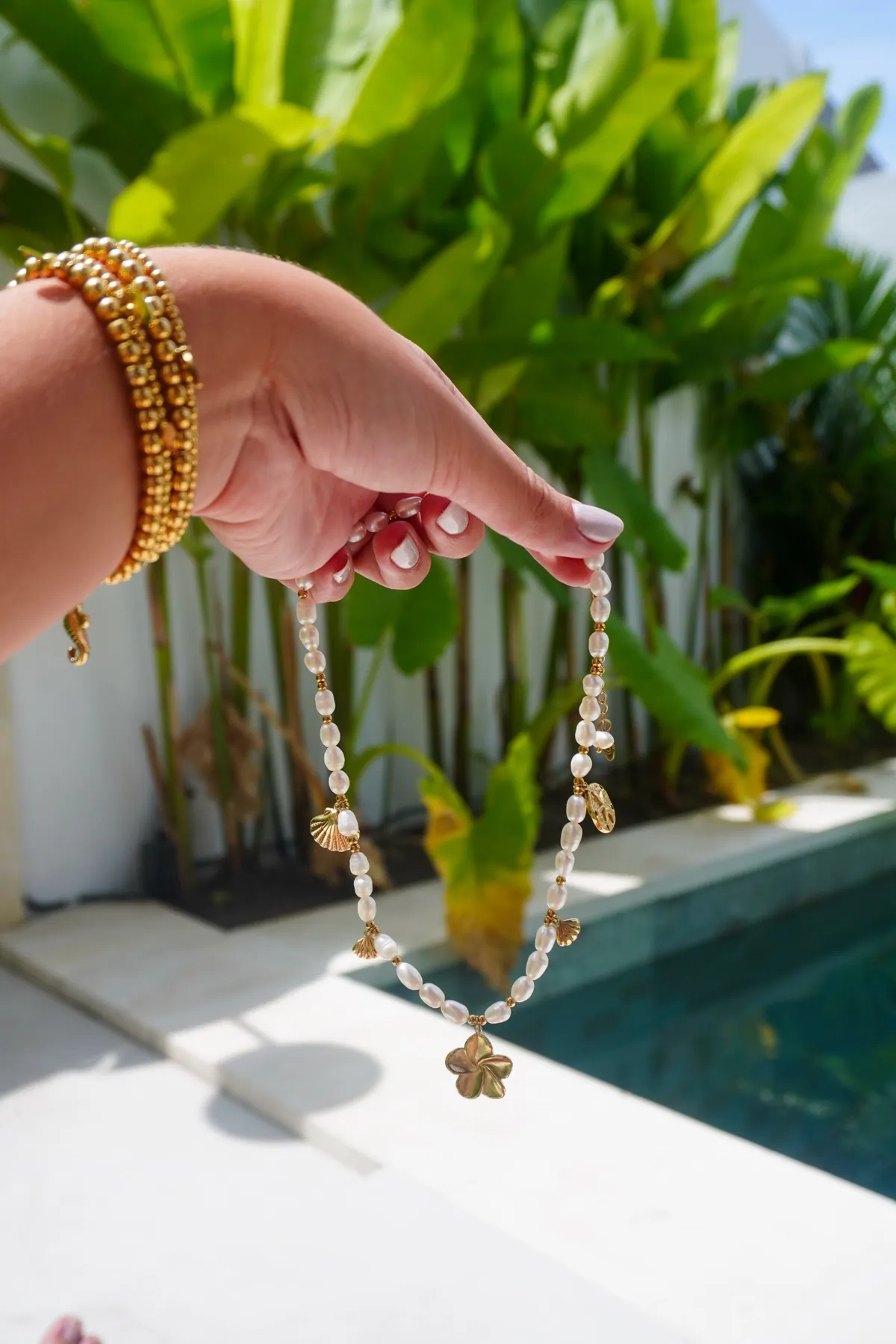 Bali Necklace, Pearl necklace with a frangipani, Stainless steel · freshwater pearls