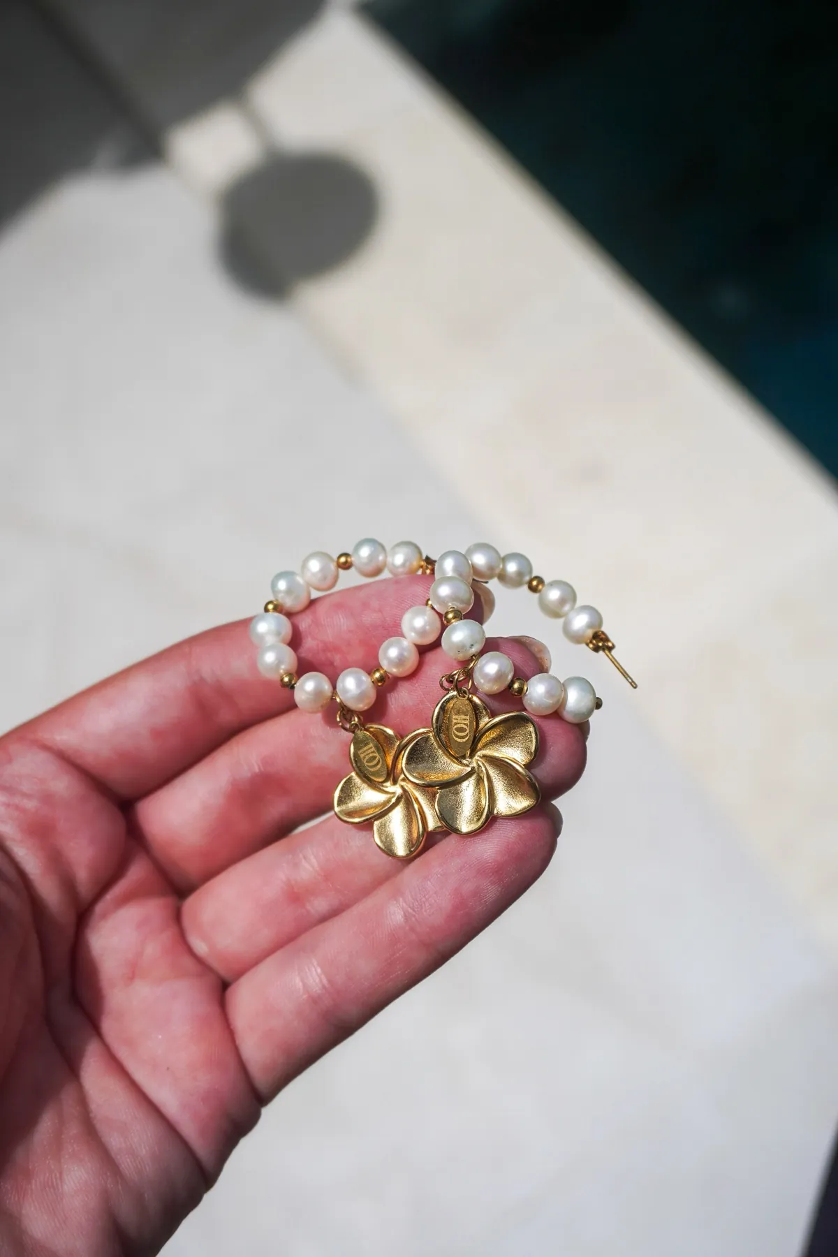 Bali Earrings, Pearl hoops with a frangipani, Stainless steel · freshwater pearls